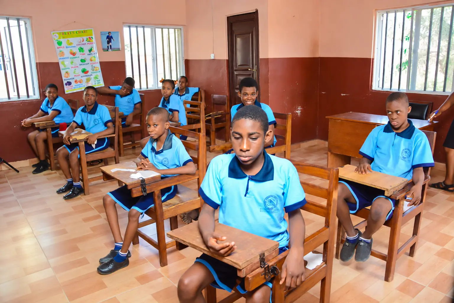 Pupils learning at individual desks in a bright classroom